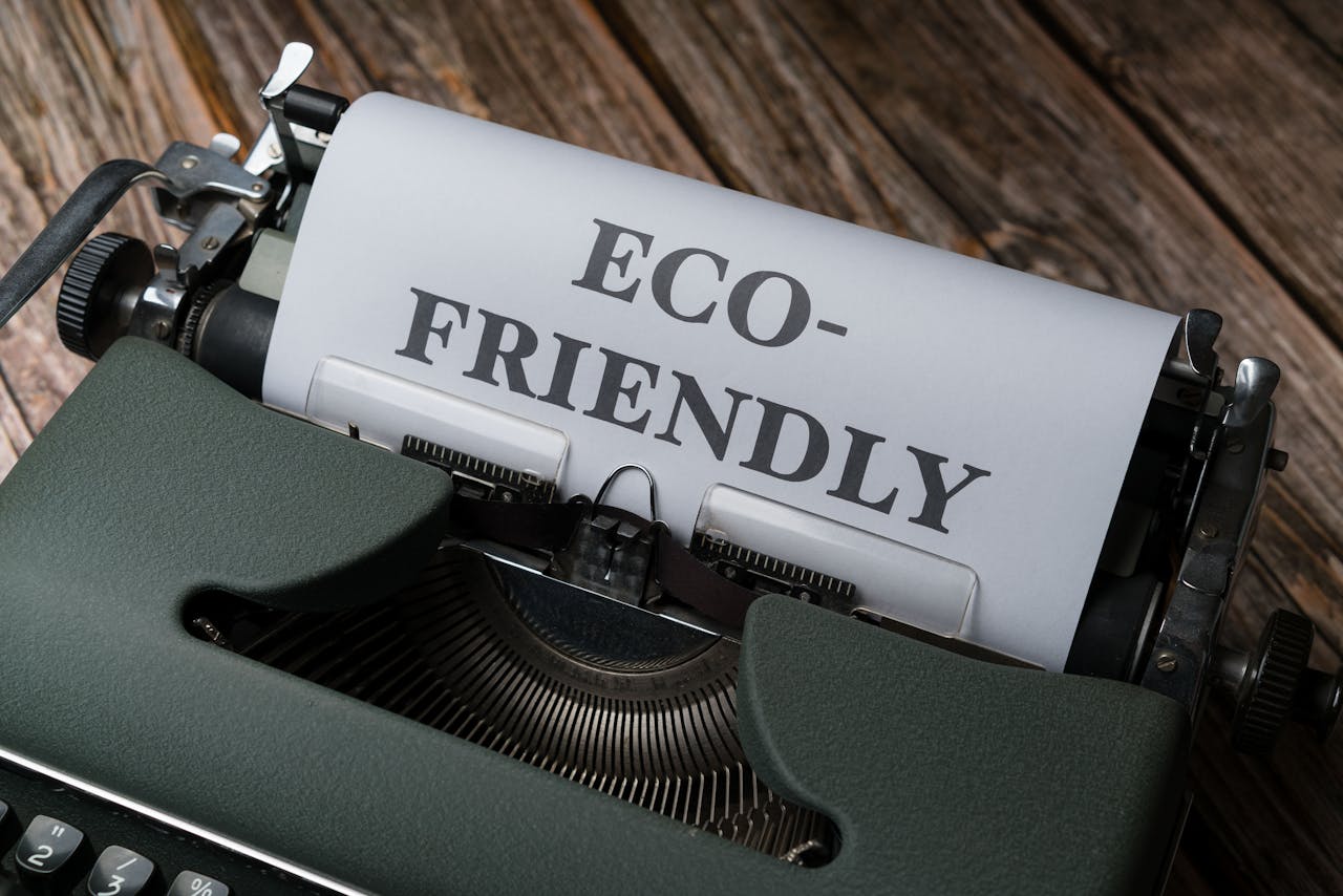 Close-up of a vintage typewriter displaying 'Eco-Friendly' on paper, promoting sustainability.